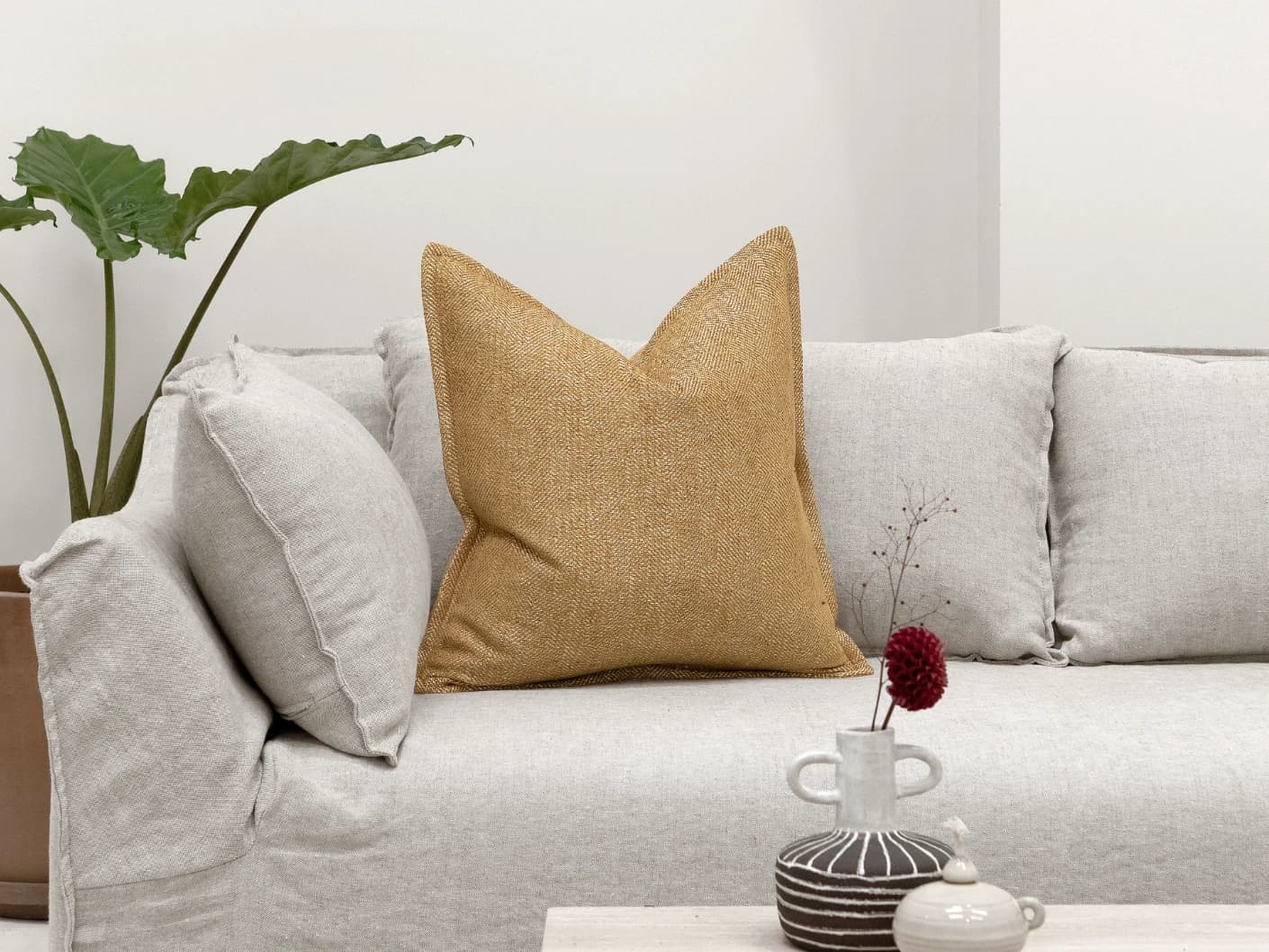 Rue Gaze single cushions in beige, shown in a lifestyle front view