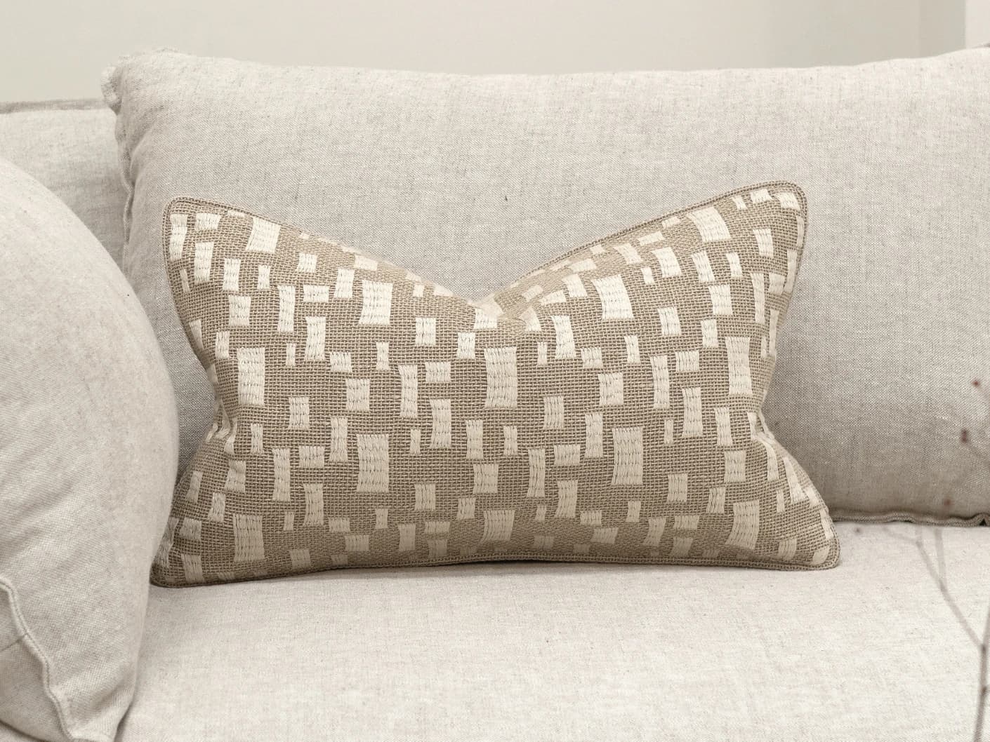 Ruth Laurent II single cushions in beige and ivory, shown in a lifestyle front view