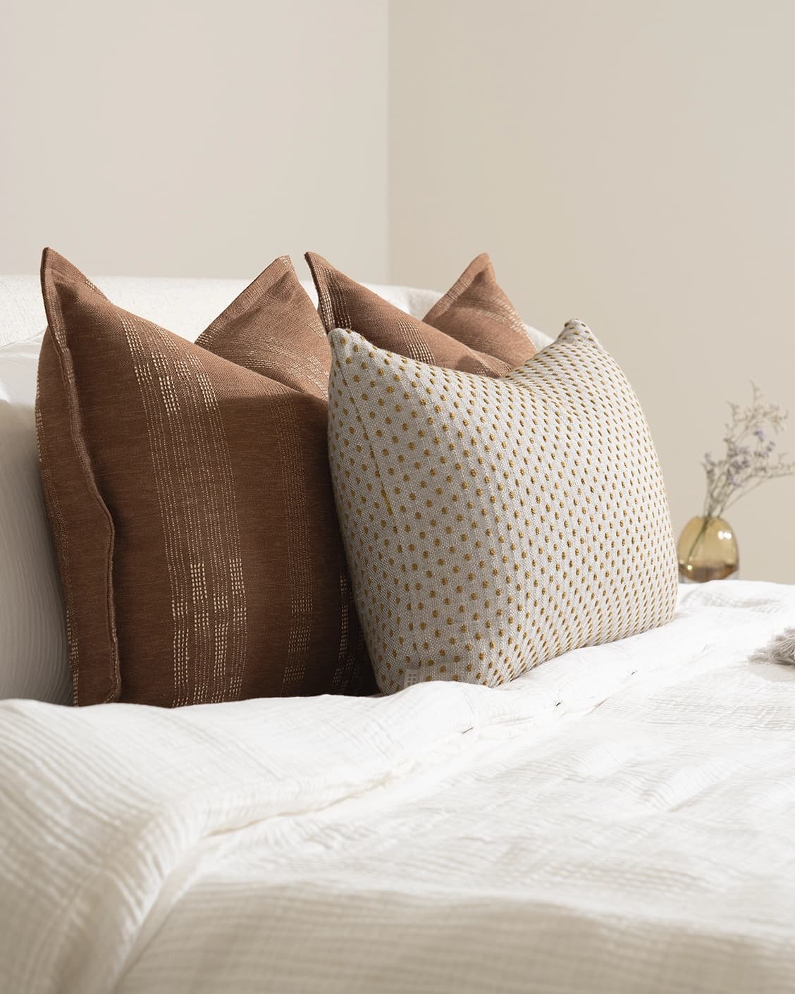 Sam Bundle cushion in brown, orange and beige, shown in a lifestyle left view as image 6