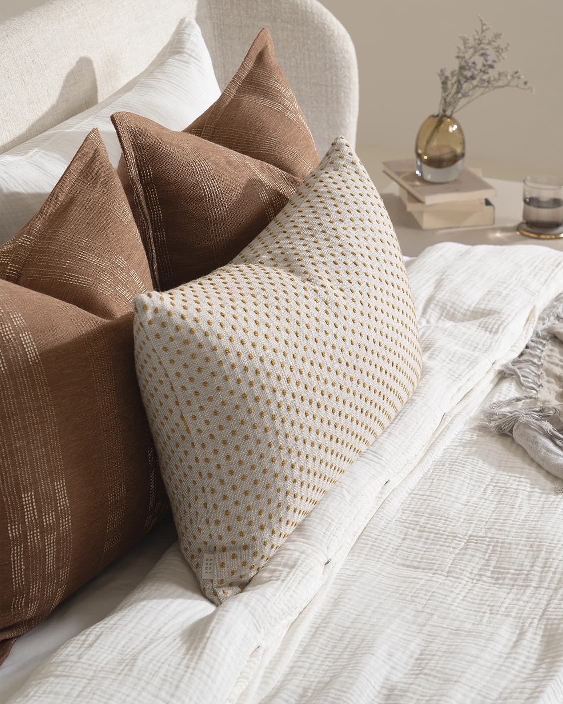 Sam Bundle cushion in brown, orange and beige, shown in a lifestyle left view as image 7