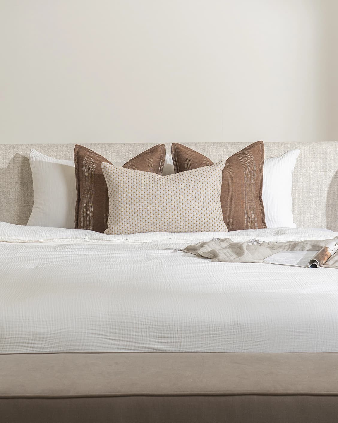 Sam Bundle cushion in brown, orange and beige, shown in a lifestyle front view as image 2
