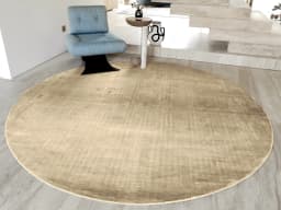 Scarlette Sandy Round carpet in sandy, beige and gold, shown in a lifestyle front view
