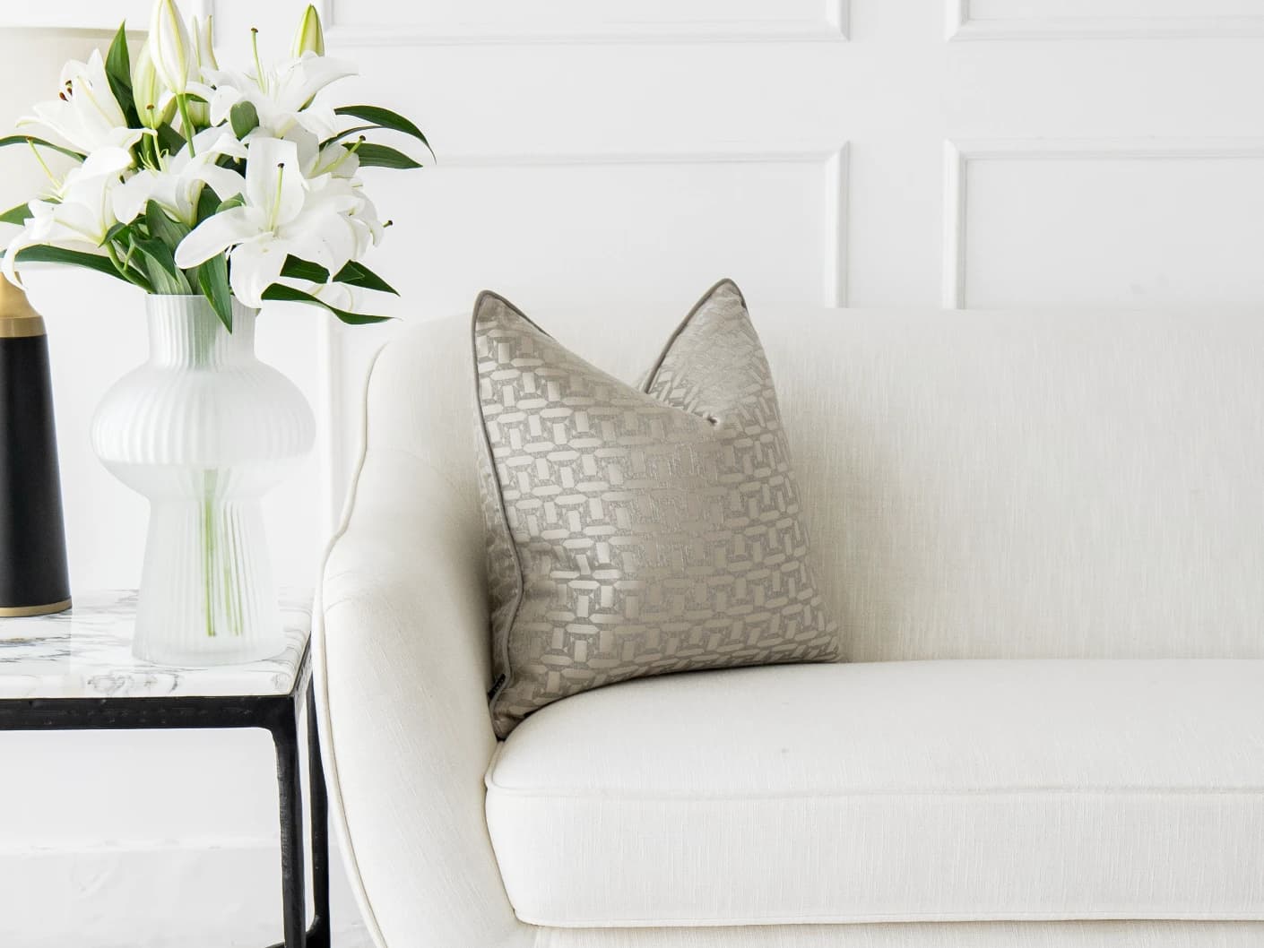Selena Laurent single cushions in white and silver, shown in a lifestyle front view