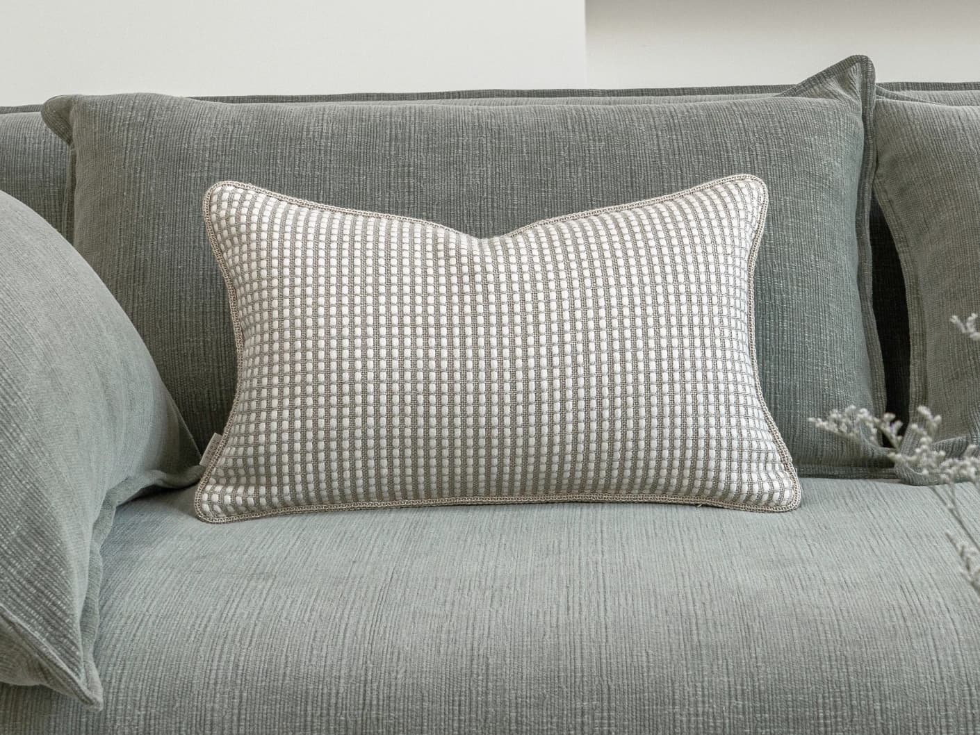 Shea Laurent II single cushions in beige, shown in a lifestyle front view