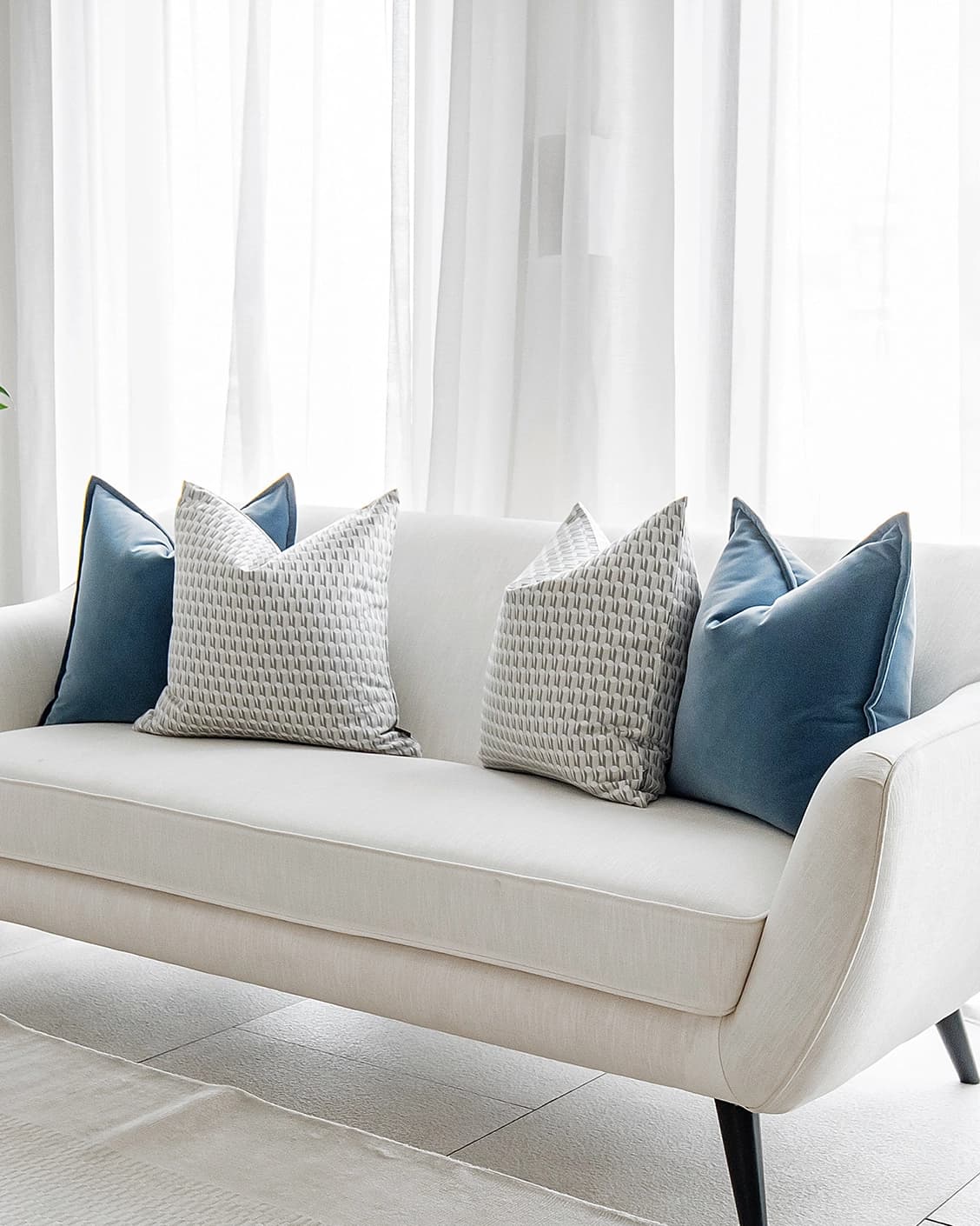 Shirley Bundle cushion in blue, white and silver, shown in a lifestyle front view as image 2