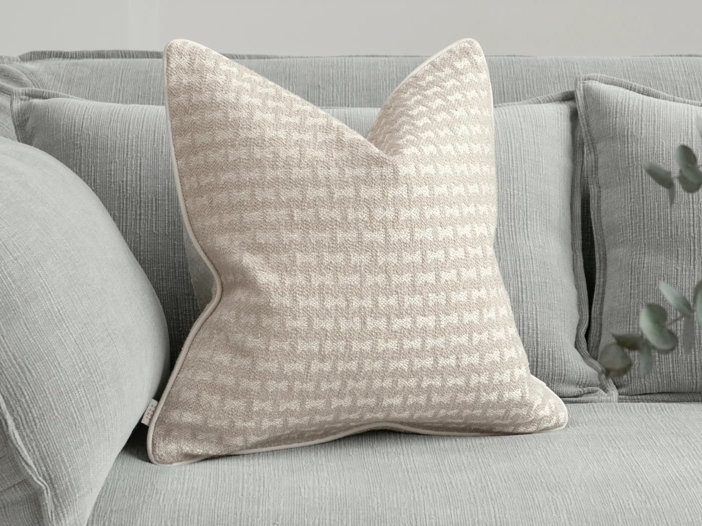 Sia Laurent single cushions in ivory, shown in a lifestyle front view