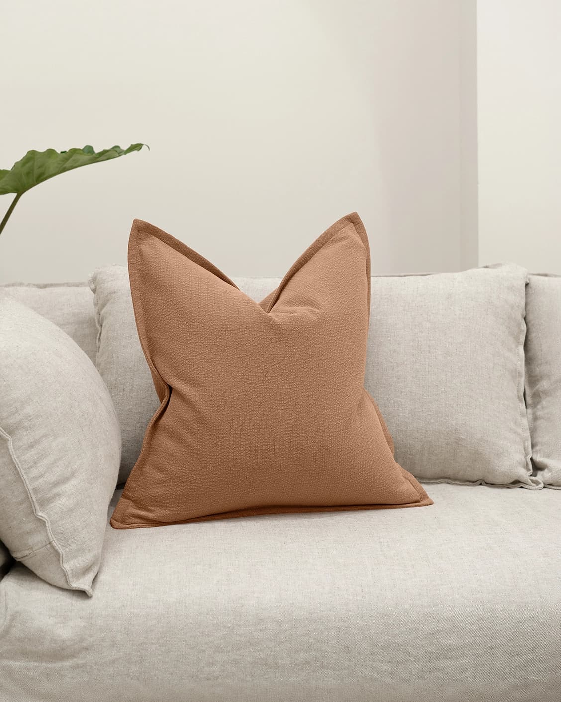 Siena Alecia cushion in orange, shown in a lifestyle front view as image 2