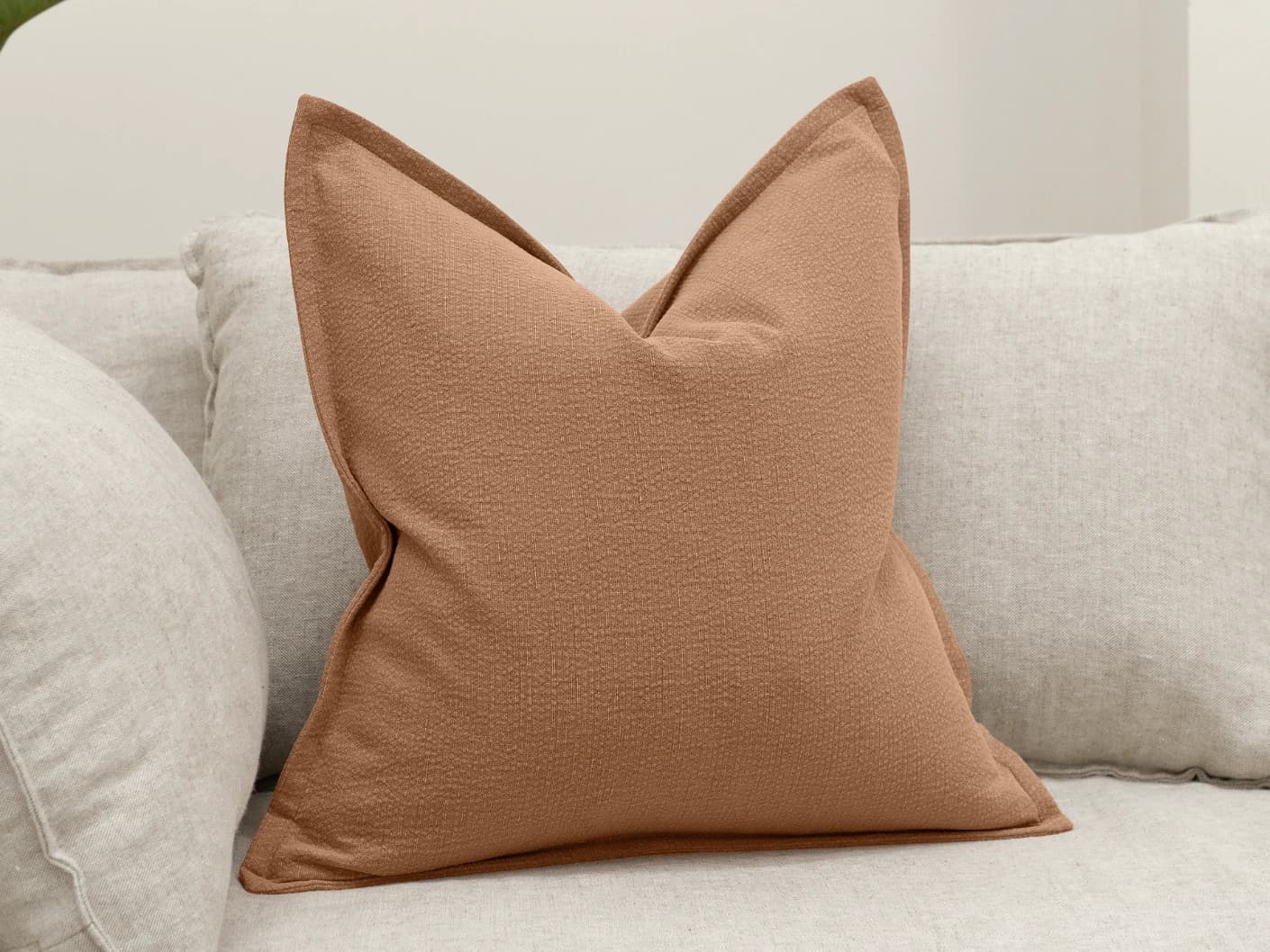 Siena Alecia single cushions in orange, shown in a lifestyle front view
