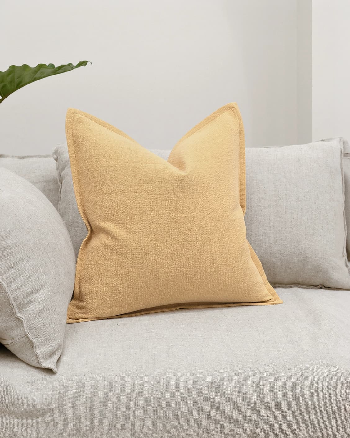 Siena Barrymore cushion in yellow, shown in a lifestyle front view as image 2
