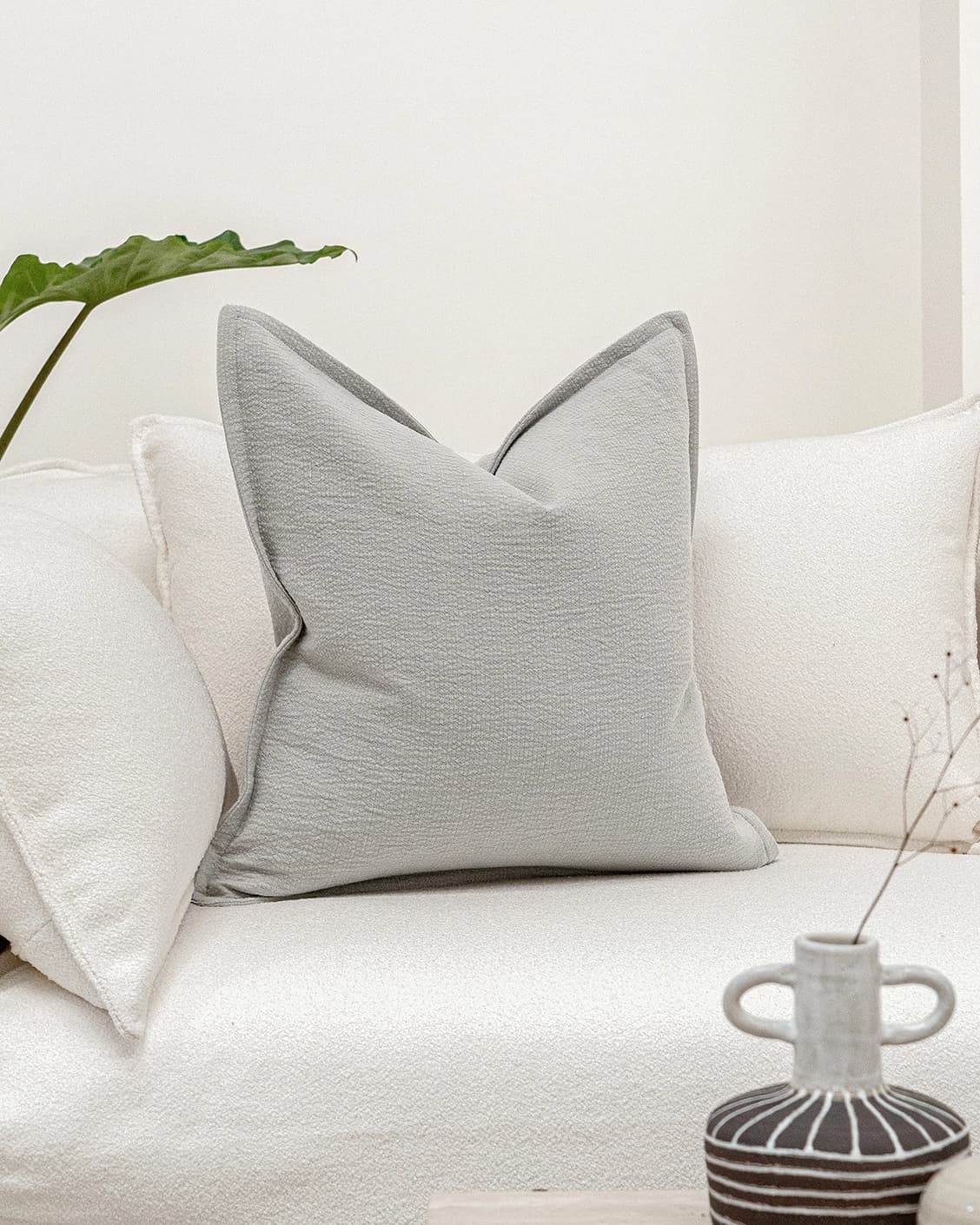 Siena Hodler cushion in grey, shown in a lifestyle front view as image 2