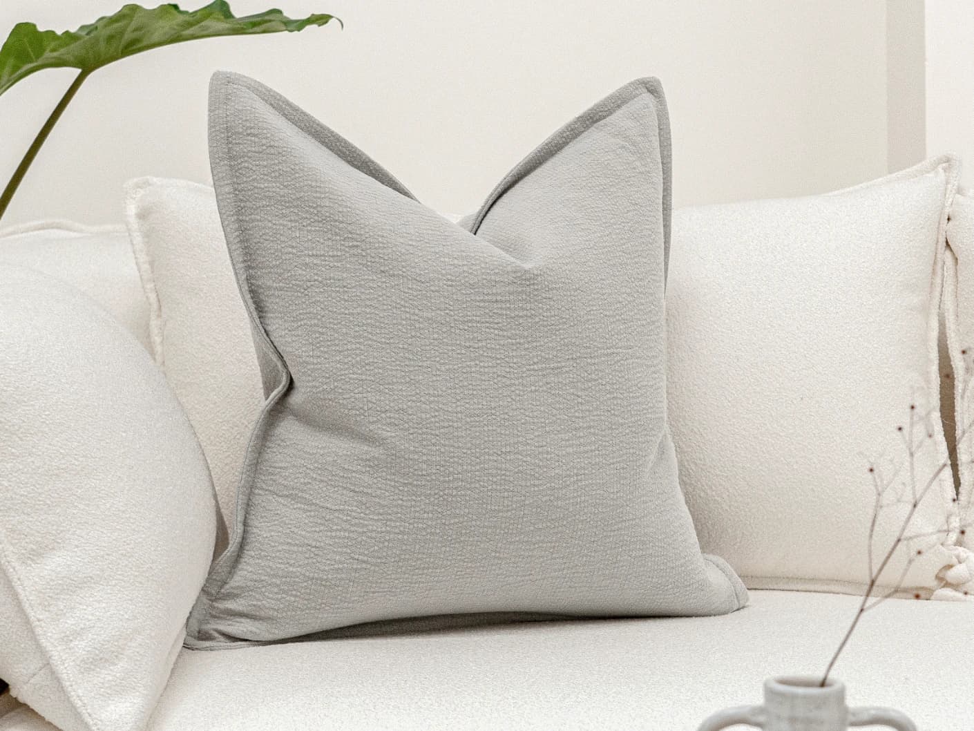 Siena Hodler single cushions in grey, shown in a lifestyle front view