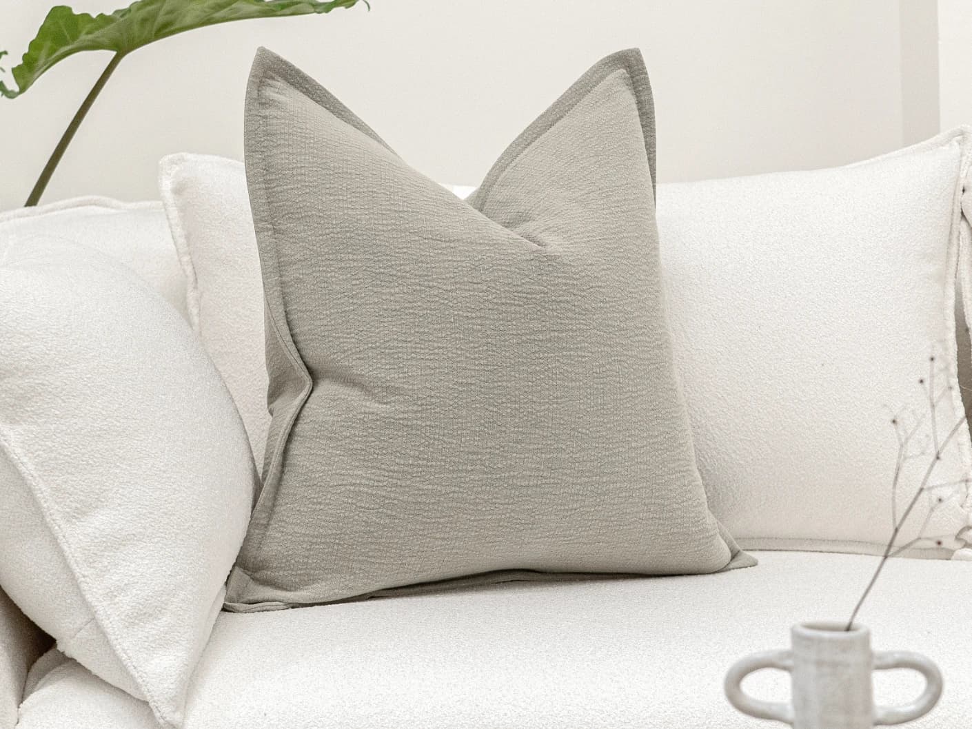 Siena Klimt single cushions in grey, shown in a lifestyle front view