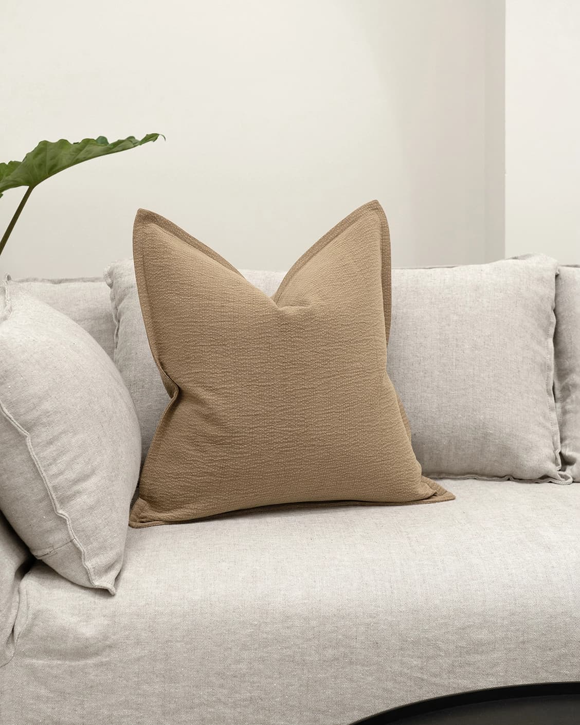 Siena Laurent cushion in brown, shown in a lifestyle front view as image 2