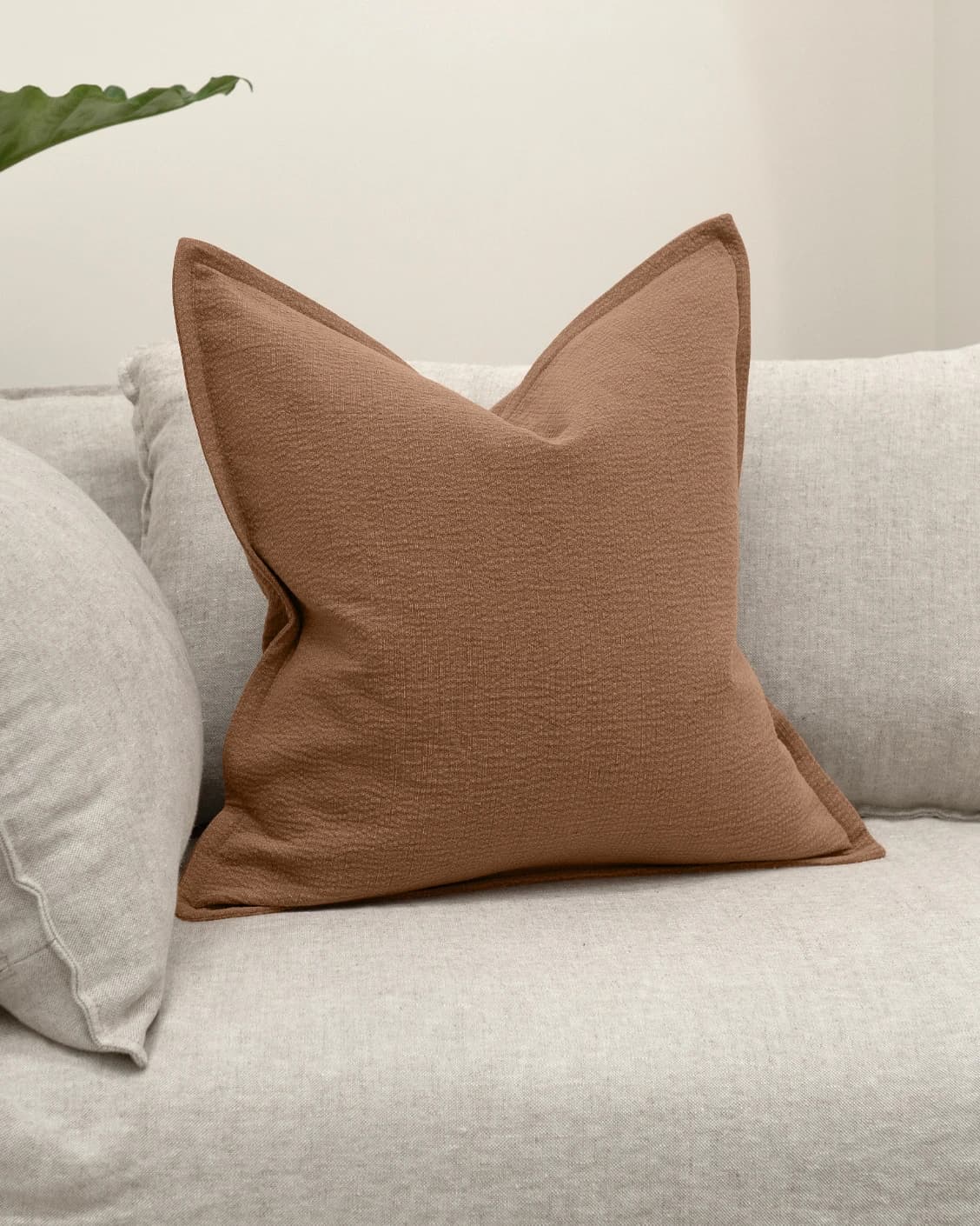 Siena Rust cushion in rust, shown in a lifestyle front view as image 2