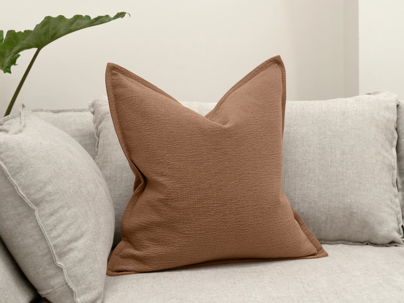 Siena Rust single cushions in rust, shown in a lifestyle front view