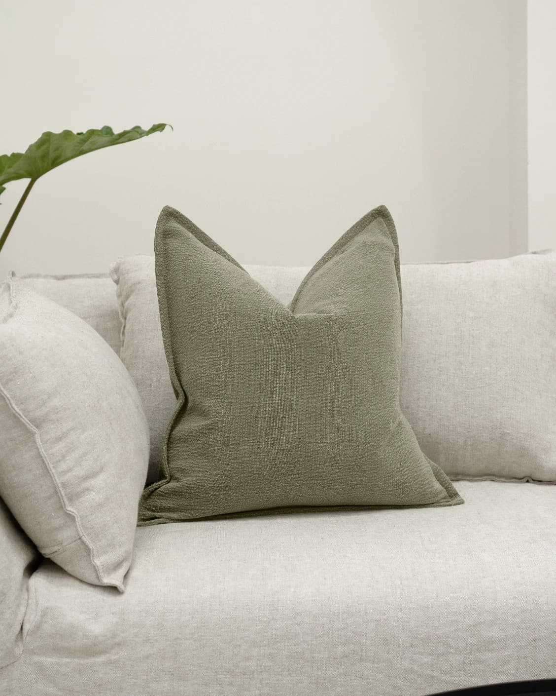 Siena Sage cushion in green, shown in a lifestyle front view as image 2