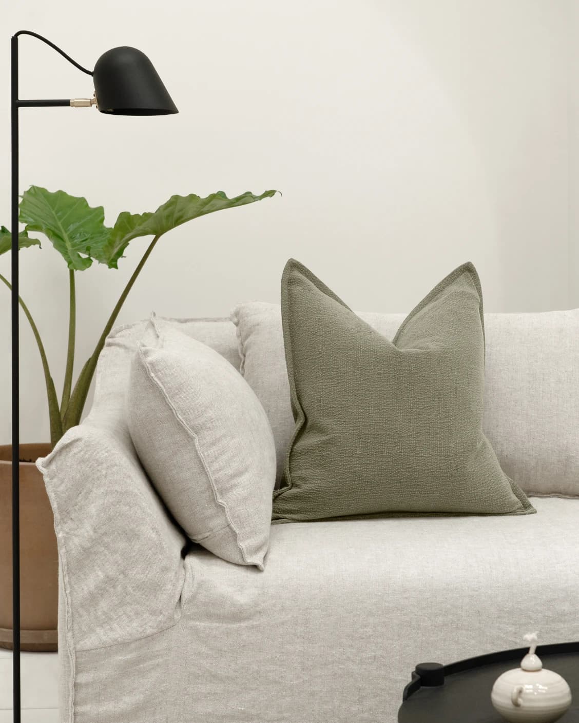 Siena Sage cushion in green, shown in a lifestyle front view as image 4