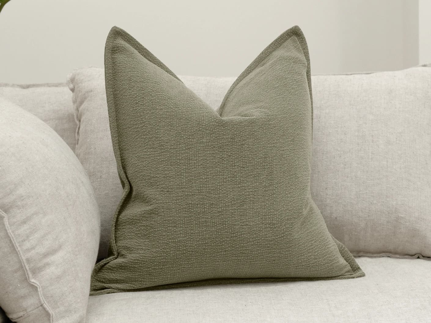 Siena Sage single cushions in green, shown in a lifestyle front view
