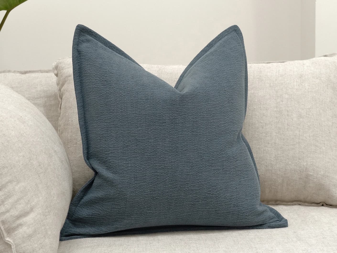 Siena Sky single cushions in sky and blue, shown in a lifestyle front view
