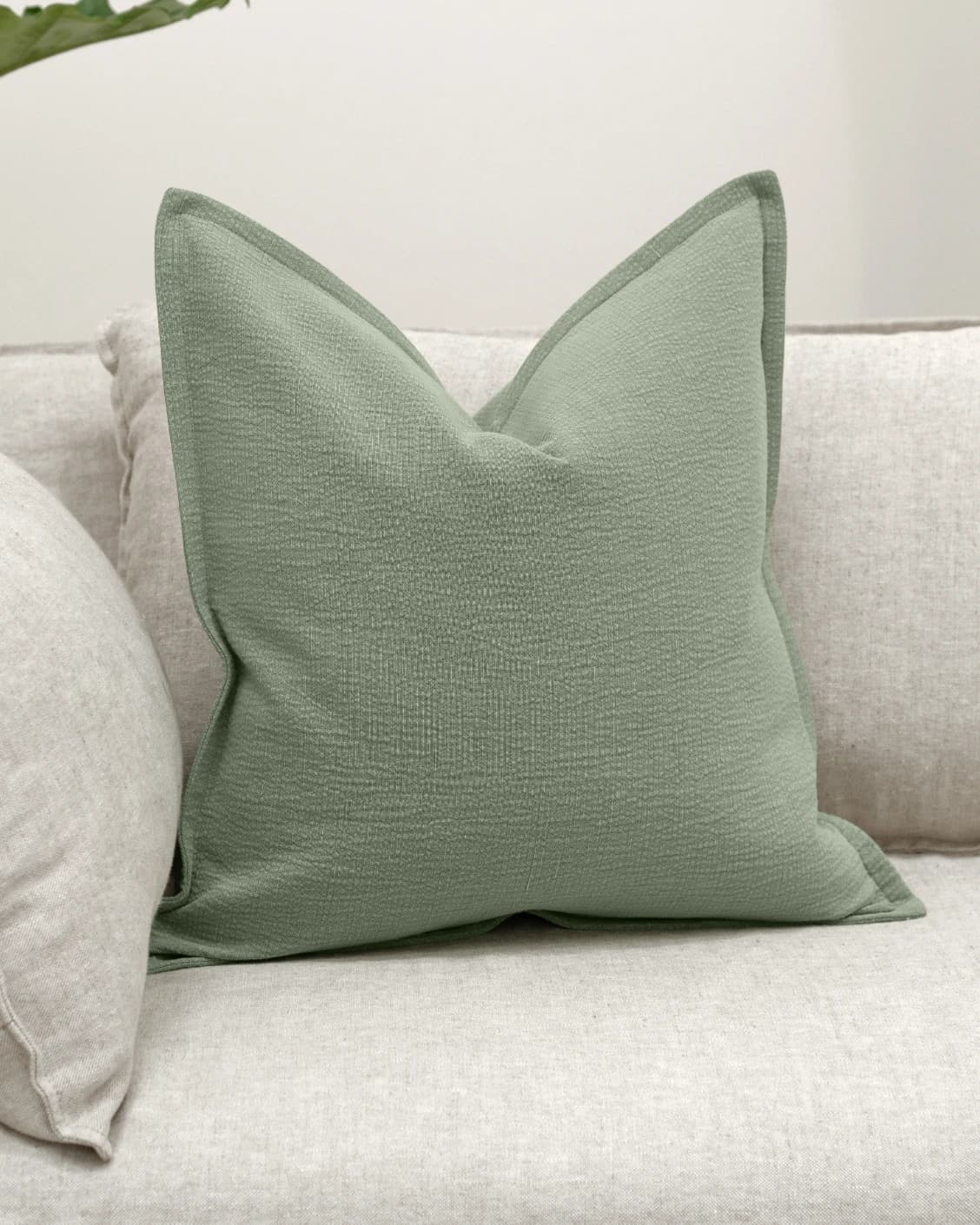 Siena Willow cushion in green, shown in a lifestyle front view as image 2