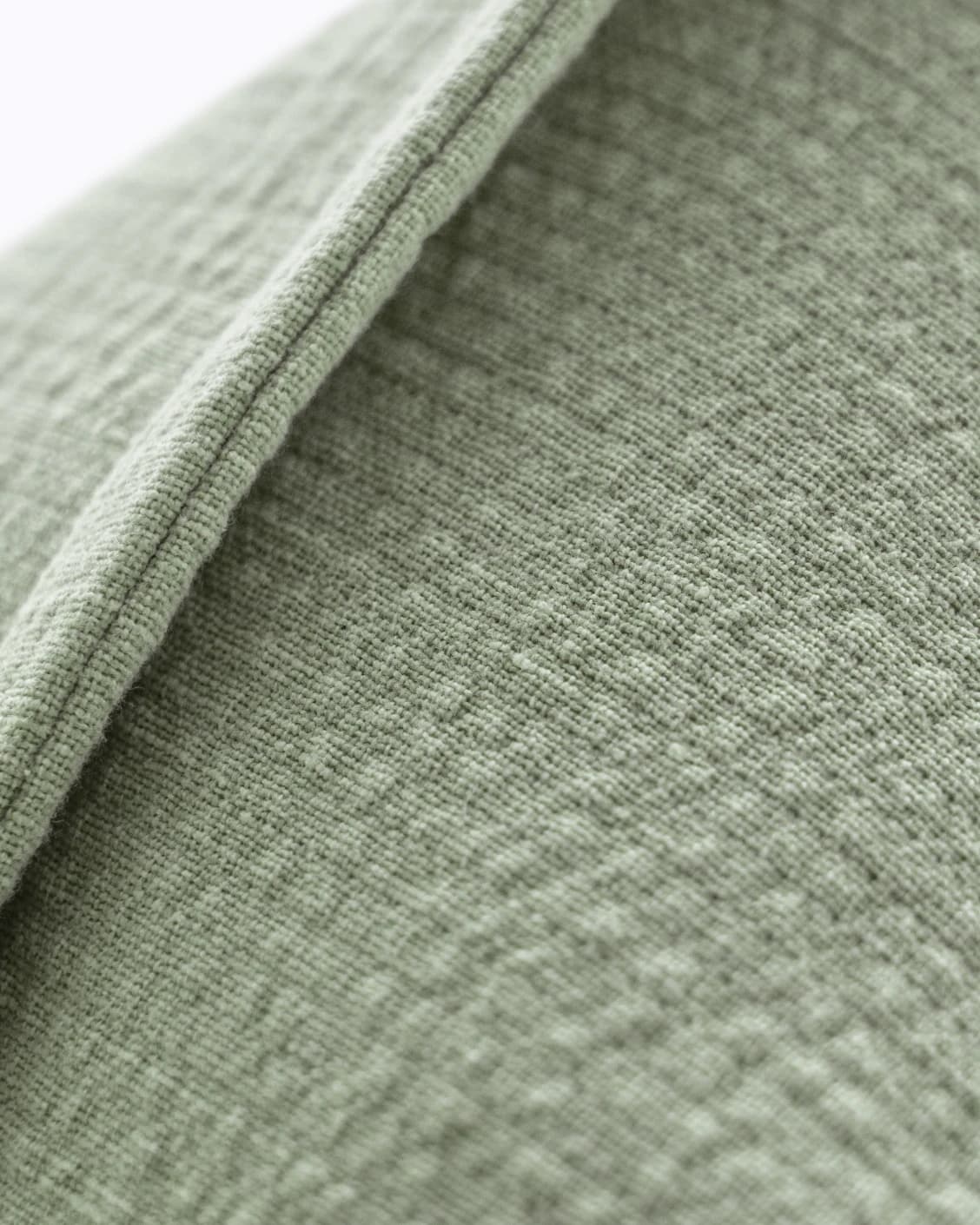 Siena Willow cushion in green, shown in a lifestyle close-up as image 4