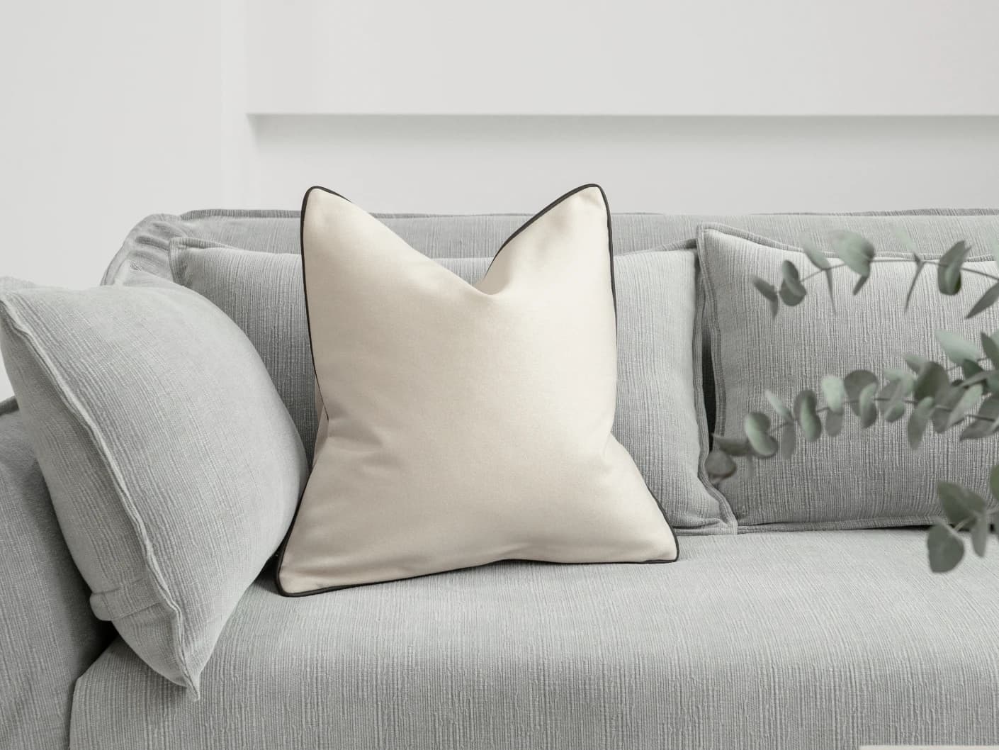 Silvie Bianca single cushions in off white, shown in a lifestyle front view