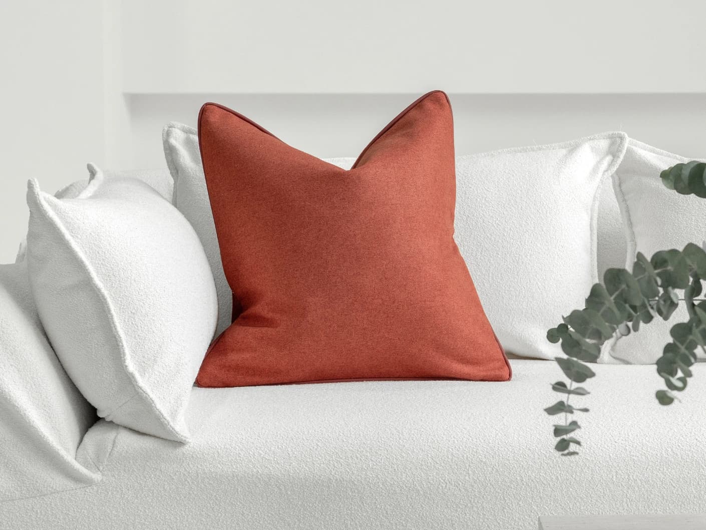 Silvie Scarlet single cushions in orange, shown in a lifestyle front view