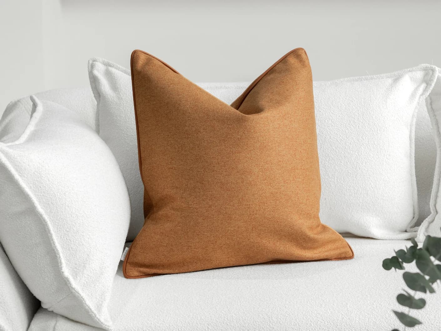 Silvie Tangelo single cushions in tangelo and rust, shown in a lifestyle front view