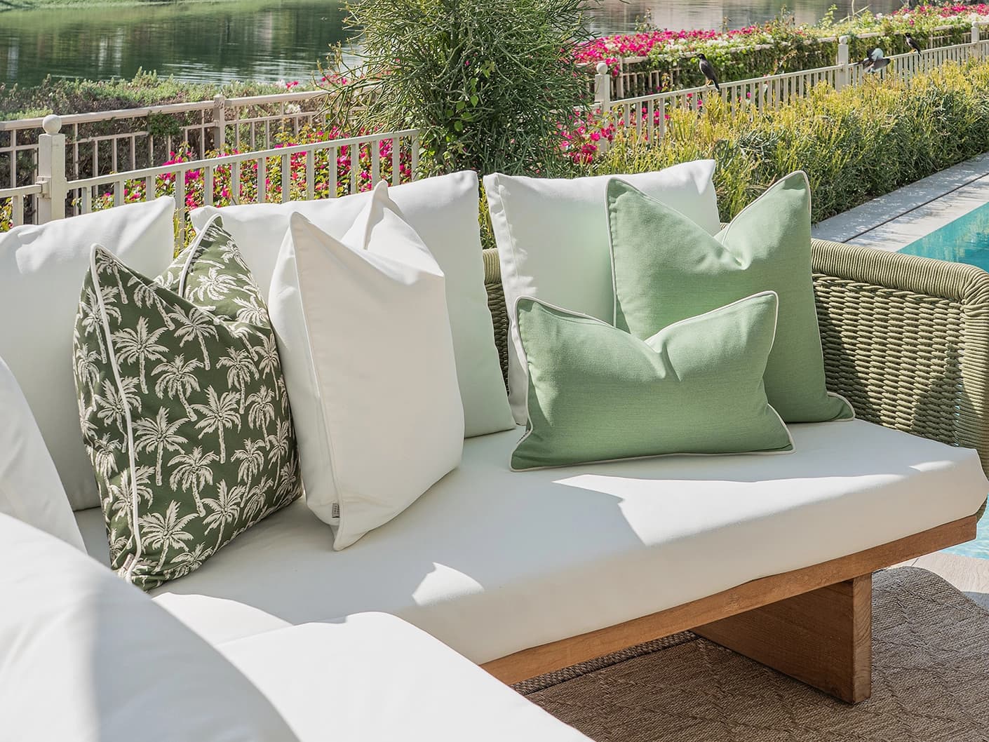 Sina Bundle bundle cushions in green and ivory, shown in a lifestyle front view
