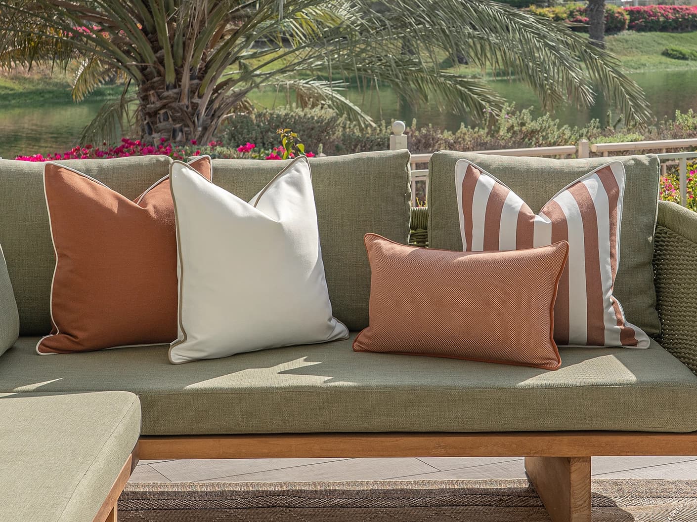 Sio Bundle bundle cushions in rust and ivory, shown in a lifestyle front view