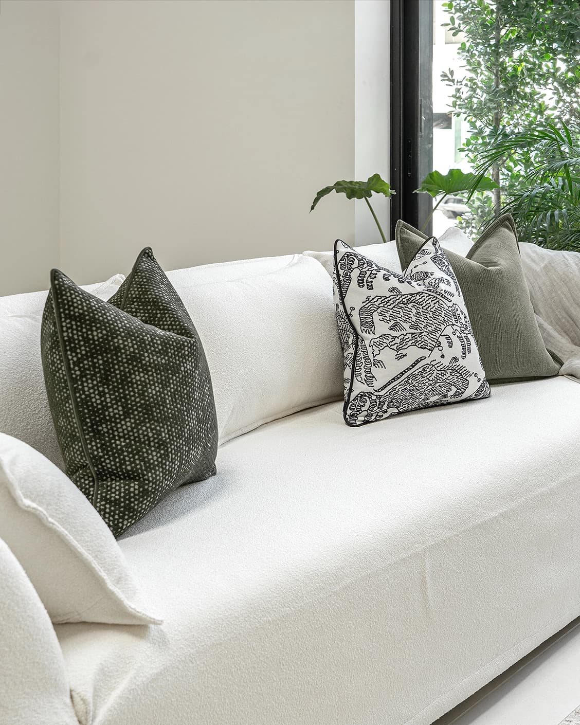 Sovi Bundle cushion in black and white, shown in a lifestyle left view as image 2