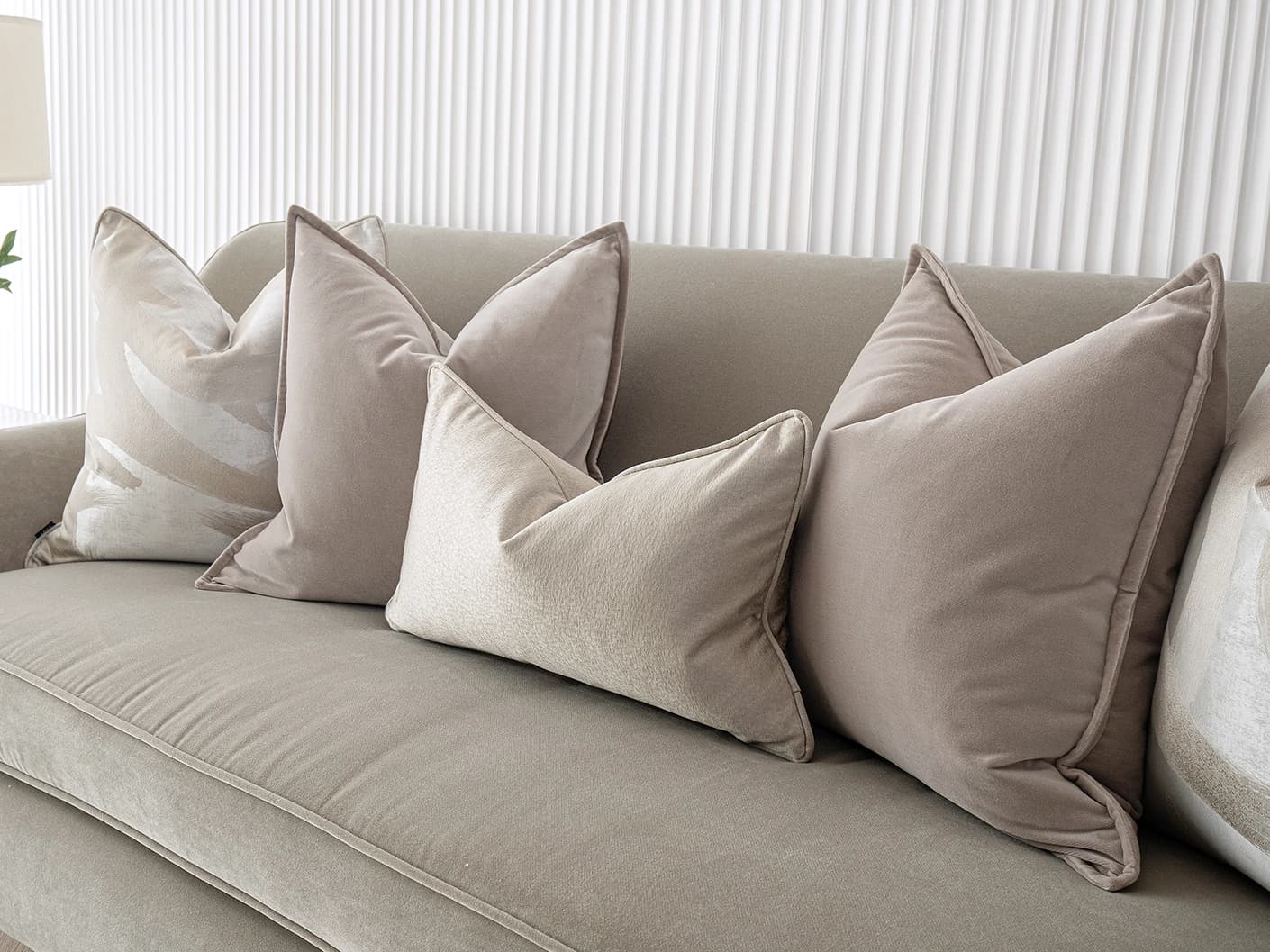 Spencer Bundle bundle cushions in beige and silver, shown in a lifestyle front view