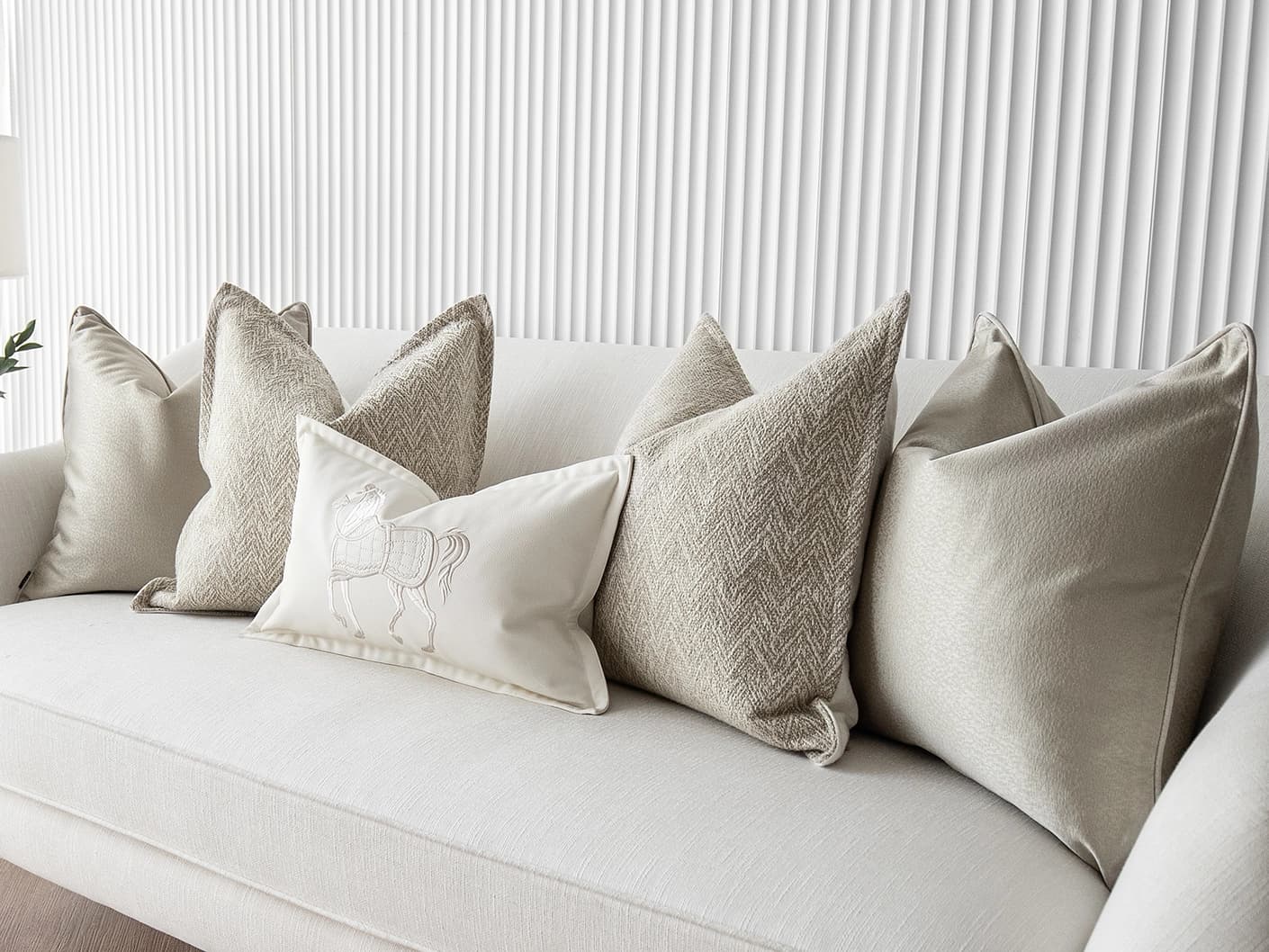 Sugar Bundle bundle cushions in gold, beige and white, shown in a lifestyle front view