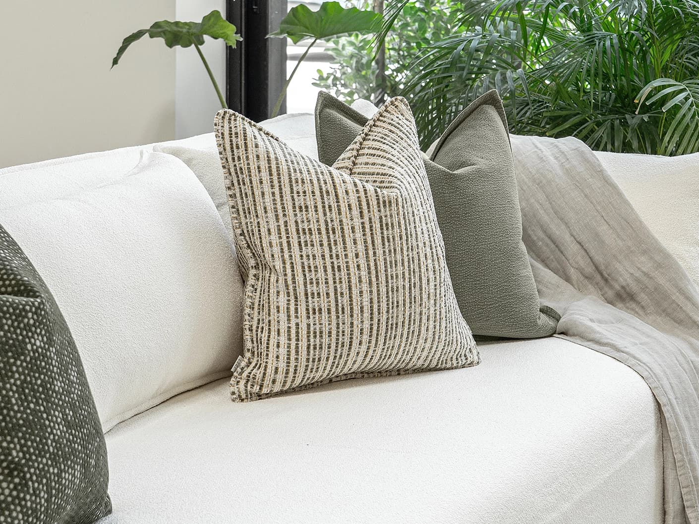 Suki Bundle bundle cushions in green and beige, shown in a lifestyle front view