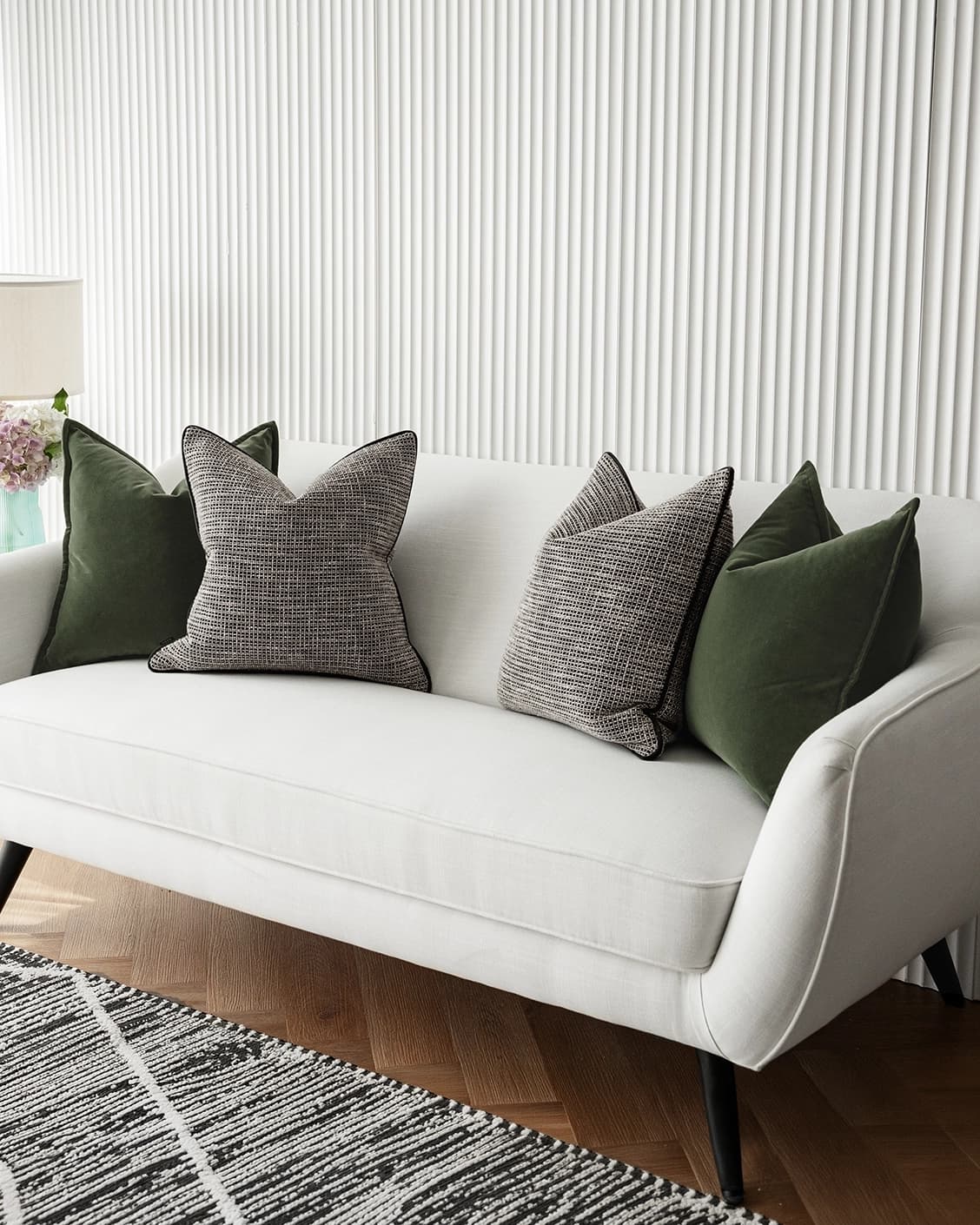Susi Bundle cushion in green and black, shown in a lifestyle right view as image 2