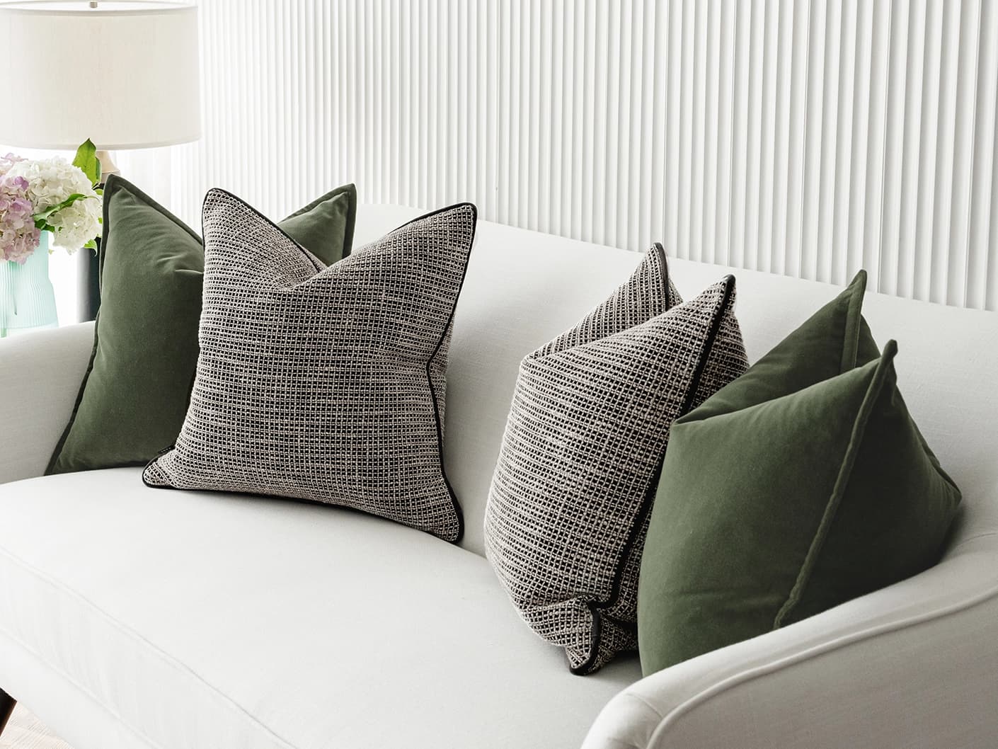 Susi Bundle bundle cushions in green and black, shown in a lifestyle front view