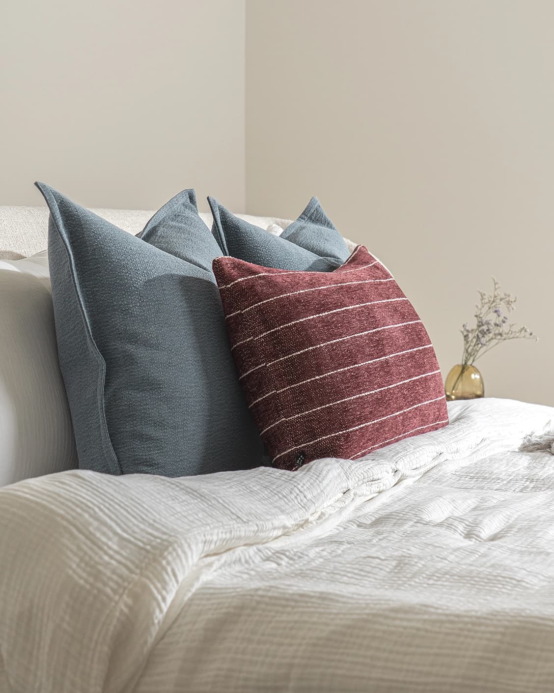 Syed Bundle cushion in blue and red, shown in a lifestyle left view as image 6