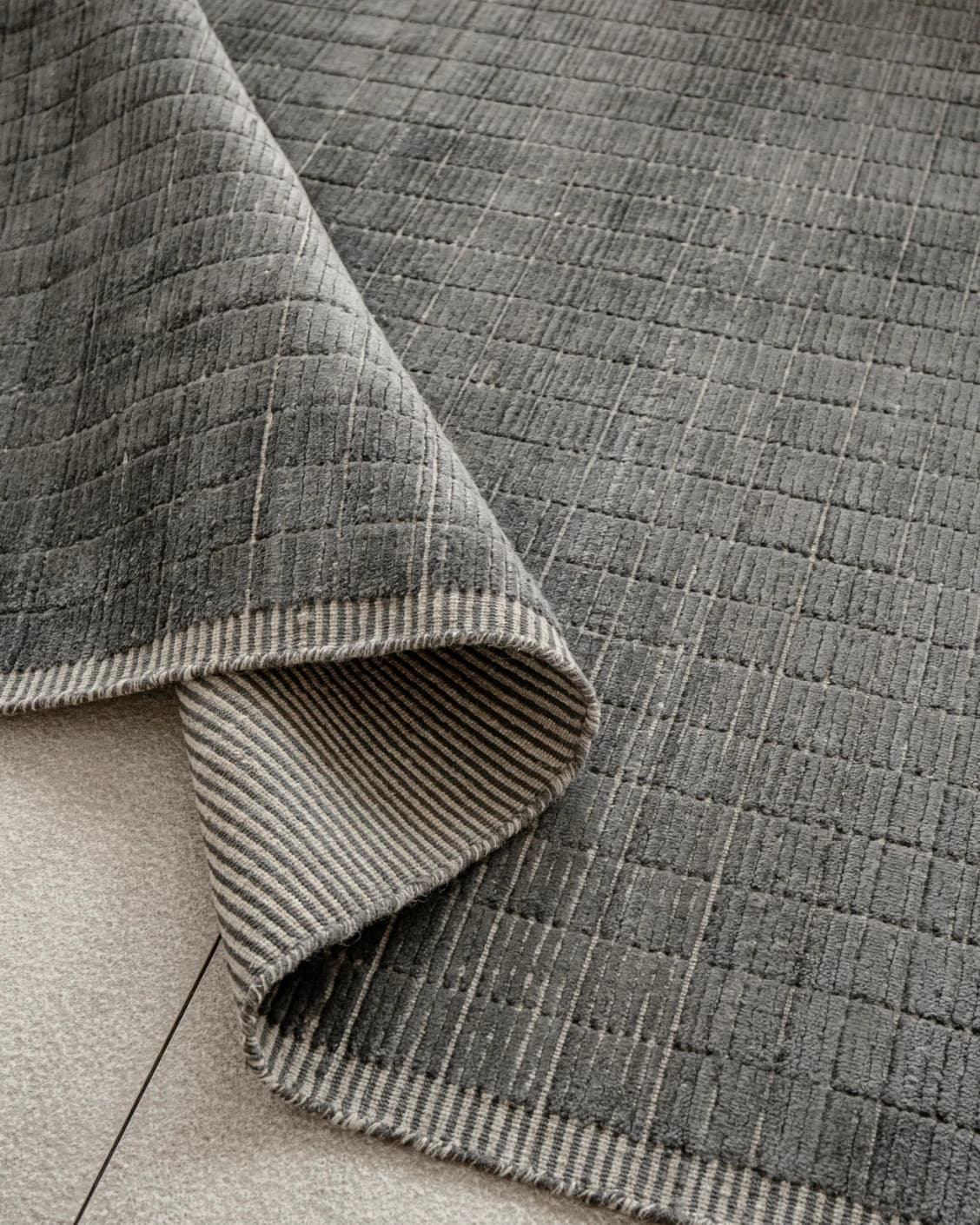 Taylor Ebony Round carpet in ebony, black and grey, shown in a product close-up as image 5