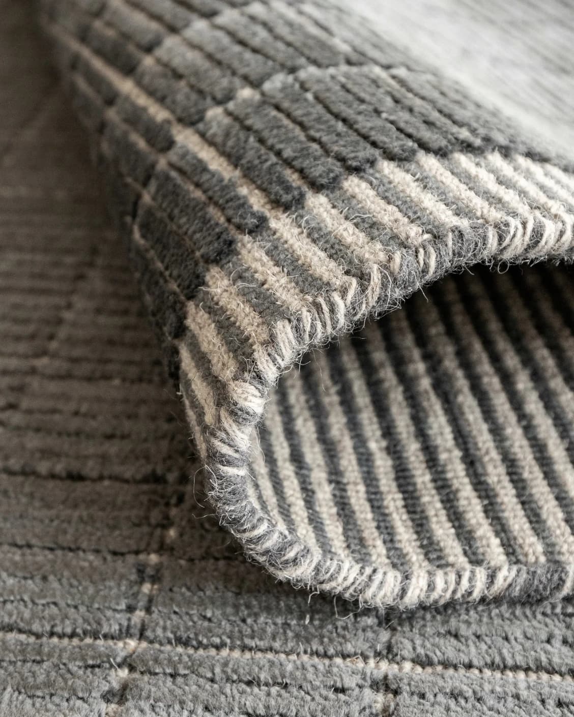 Taylor Ebony Round carpet in ebony, black and grey, shown in a product close-up as image 6
