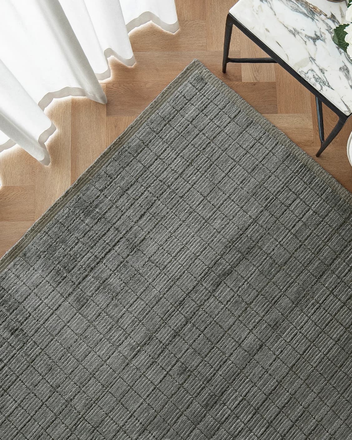 Taylor Ebony carpet in ebony, black and grey, shown in a lifestyle top view as image 2