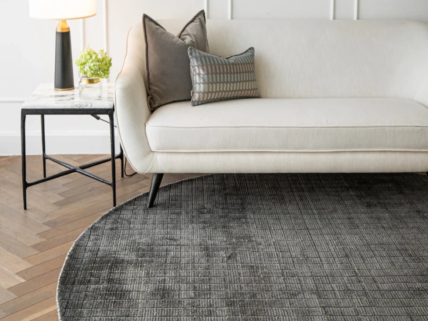 Taylor Ebony Round carpet in black and grey, shown in a lifestyle front view