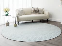 Taylor Sky Round carpet in sky, shown in a lifestyle front view