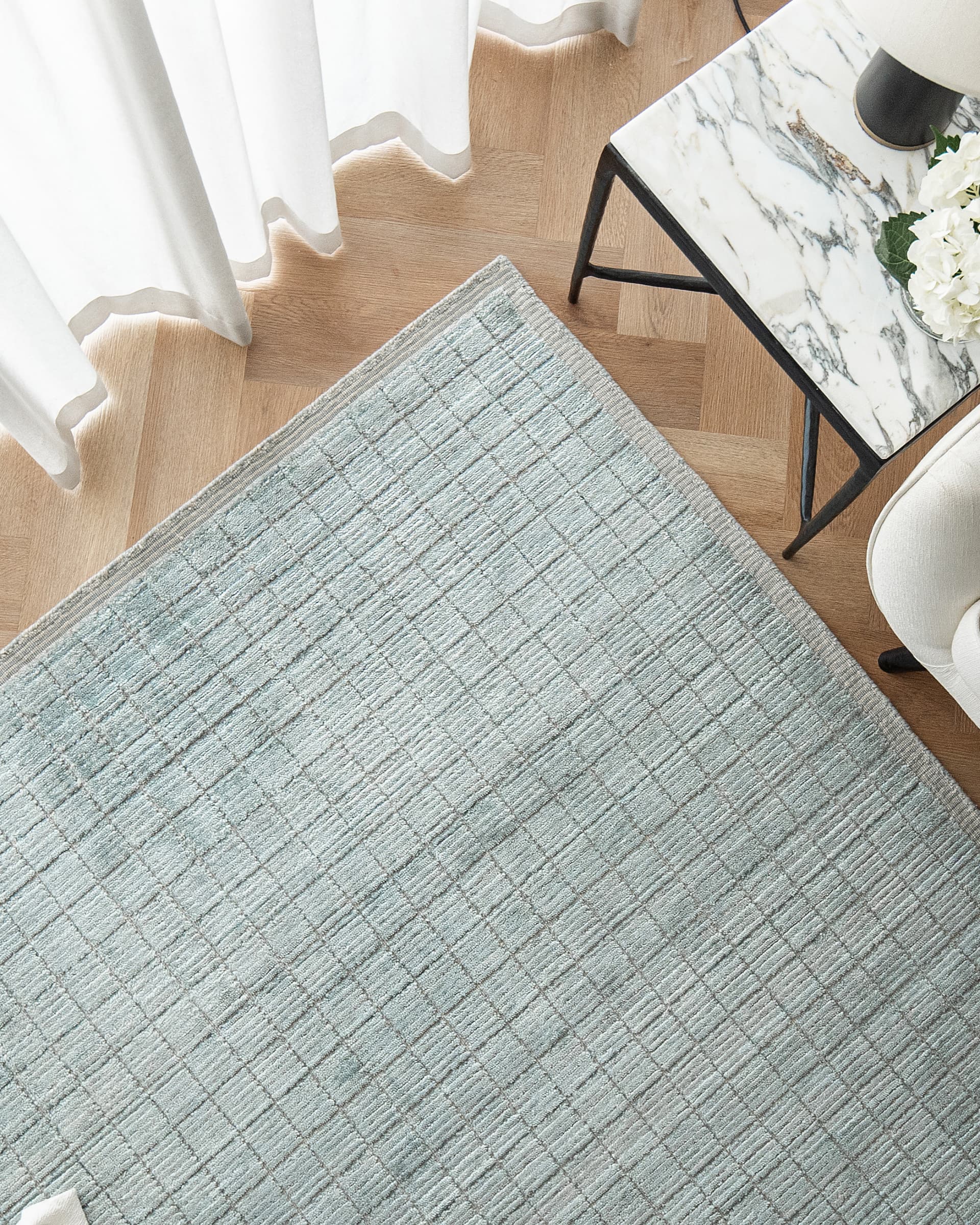 Taylor Sky Round carpet in sky, shown in a lifestyle top view as image 4
