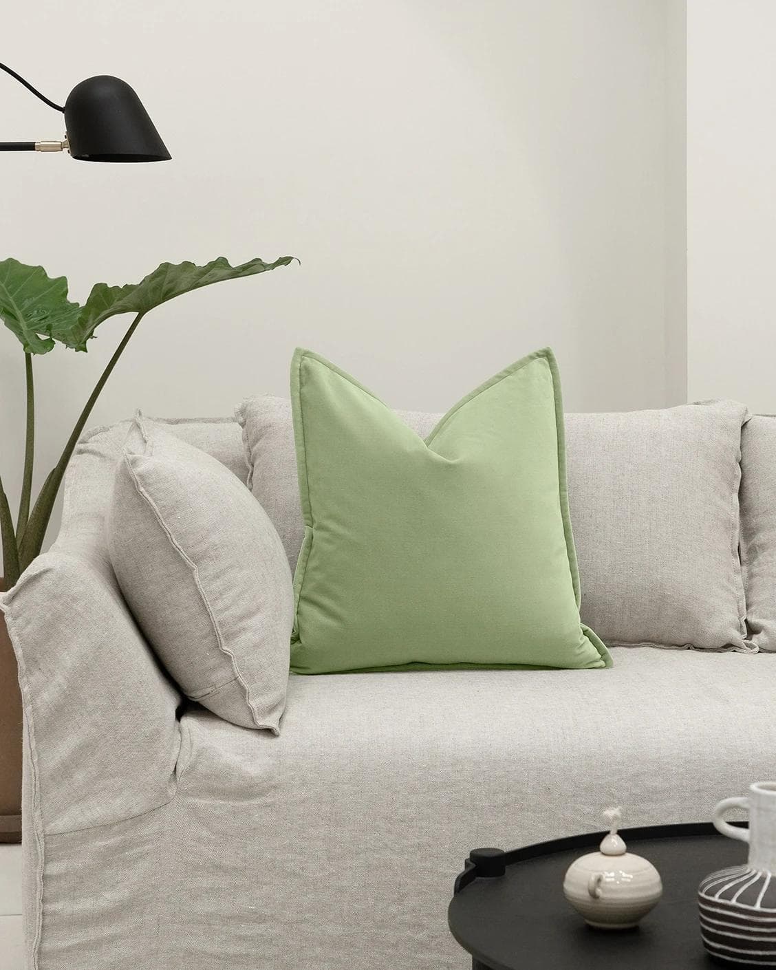Alessandra Pistachio cushion in green, shown in a lifestyle front view as image 4
