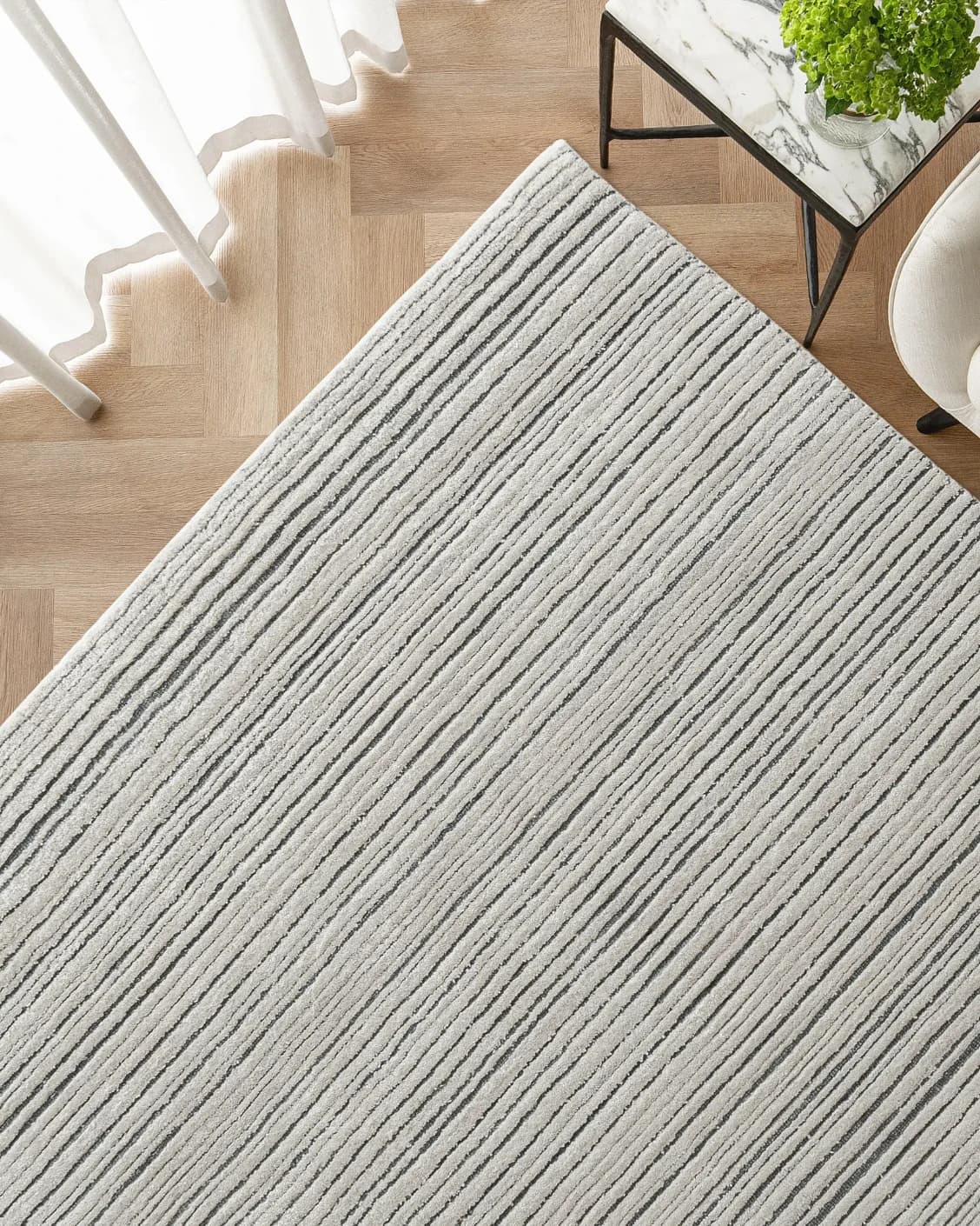 Theodore Ashton carpet in grey and ivory, shown in a lifestyle top view as image 2