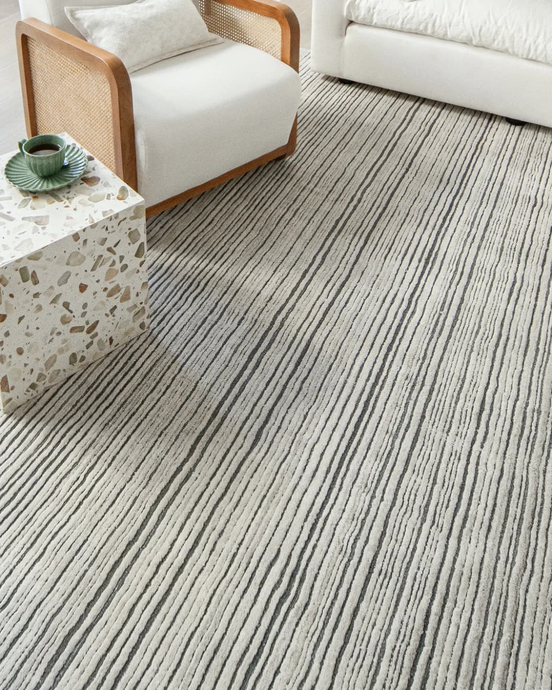 Theodore Ashton carpets in grey and ivory, shown in a lifestyle close-up as image 2