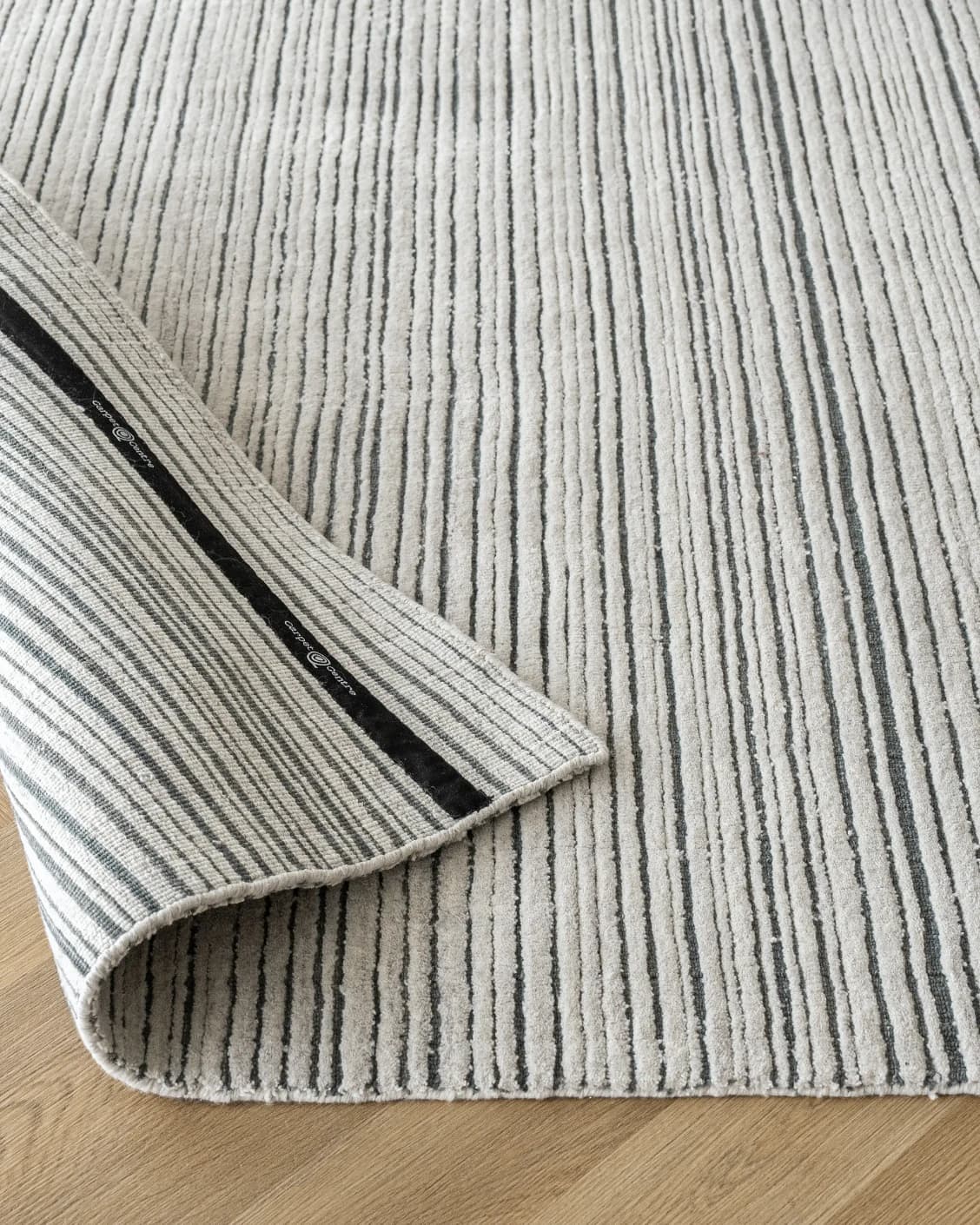 Theodore Ashton carpet in grey and ivory, shown in a product close-up as image 11