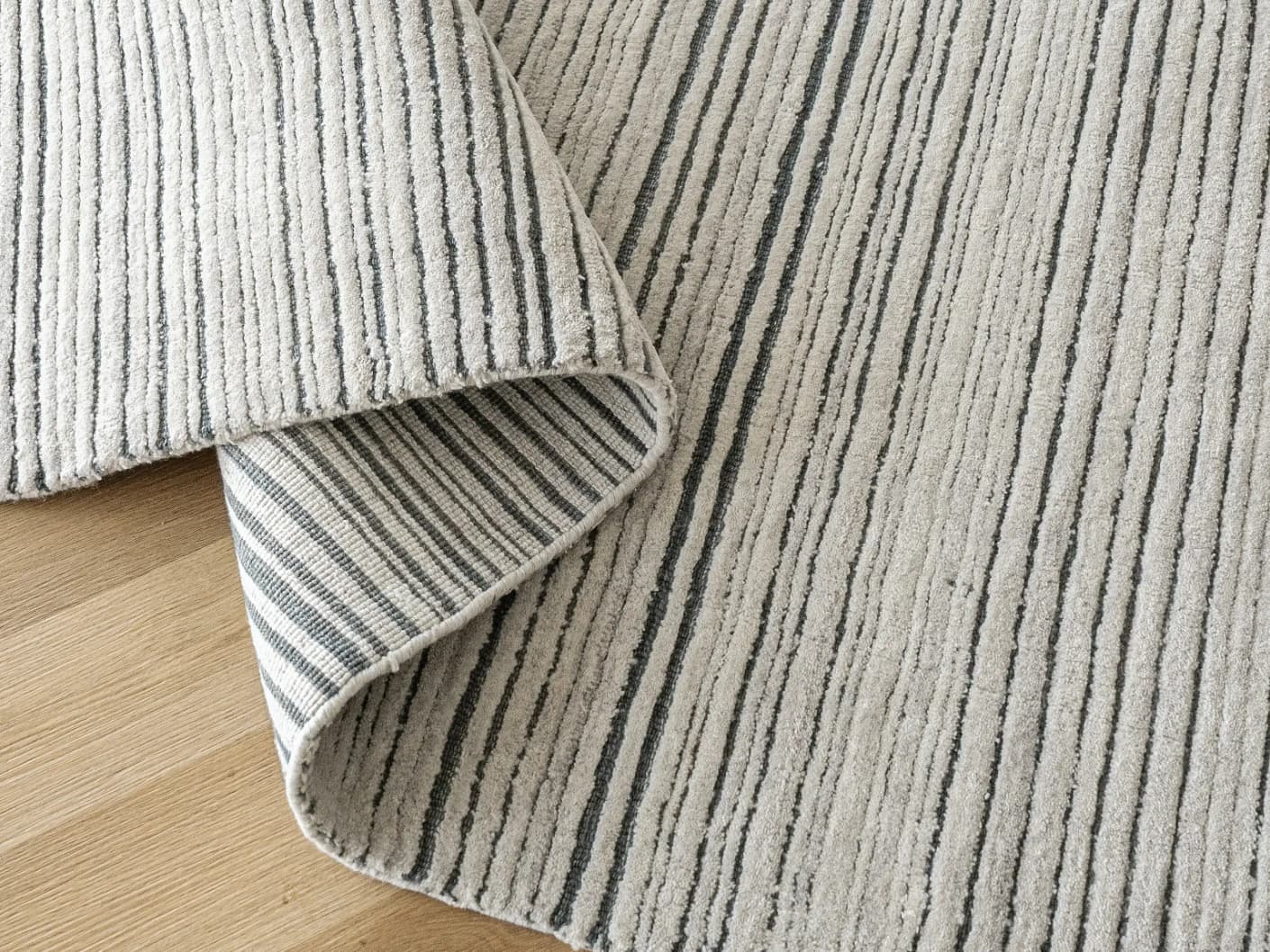 Theodore Ashton carpets in grey and ivory, shown in a product close-up view