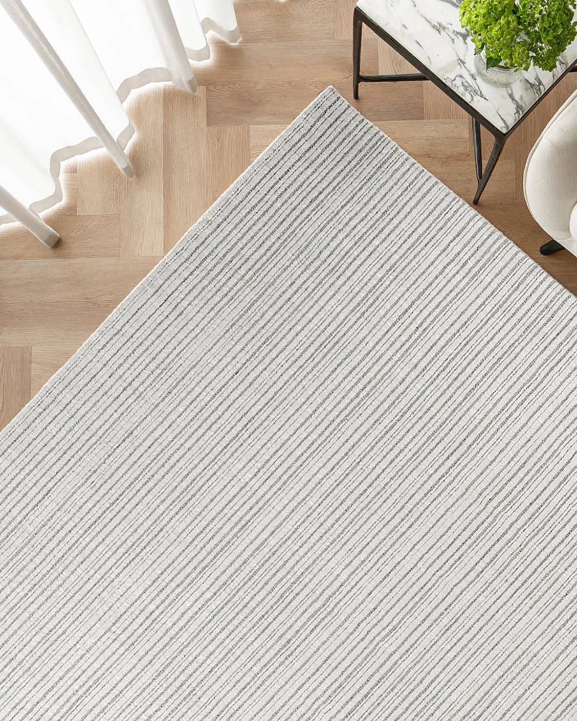 Theodore Dune carpet in dune, grey and white, shown in a lifestyle top view as image 2