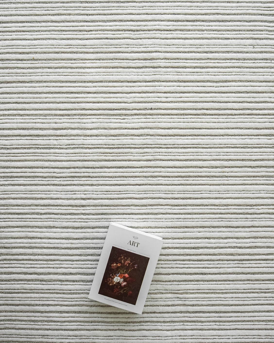 Theodore Dune carpet in dune, grey and white, shown in a lifestyle top view as image 9